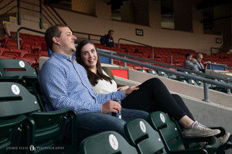 couple sits at Buffalo Bisons game sipping beer and chatting