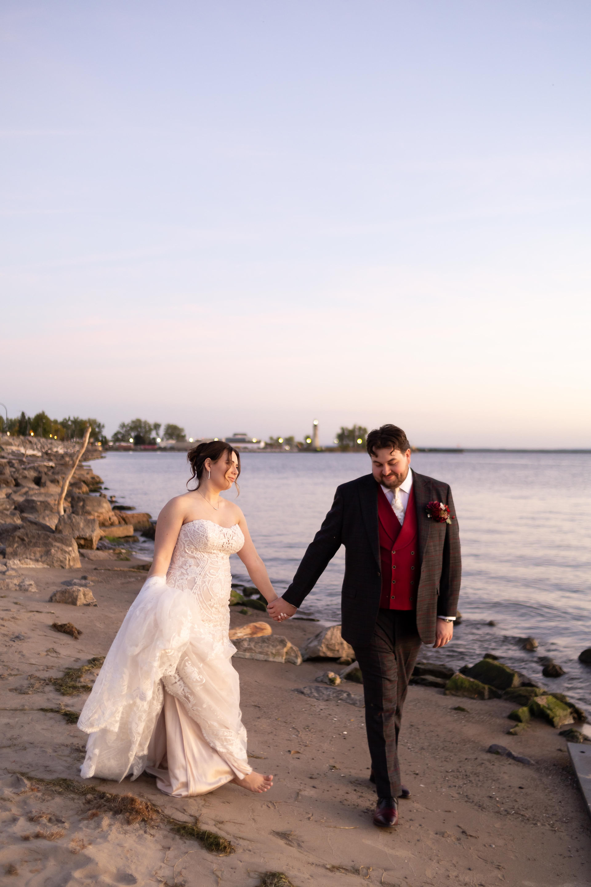 wedding couple walks along lake erie beach