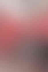 close up of man and womans hands holding on top of a red blanket, her brown boots peek out
