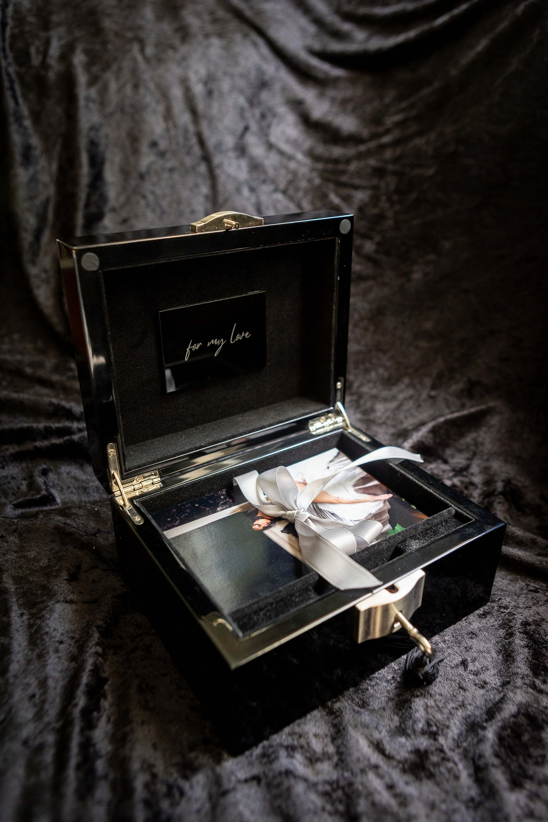 black lock box with boudoir photos inside
