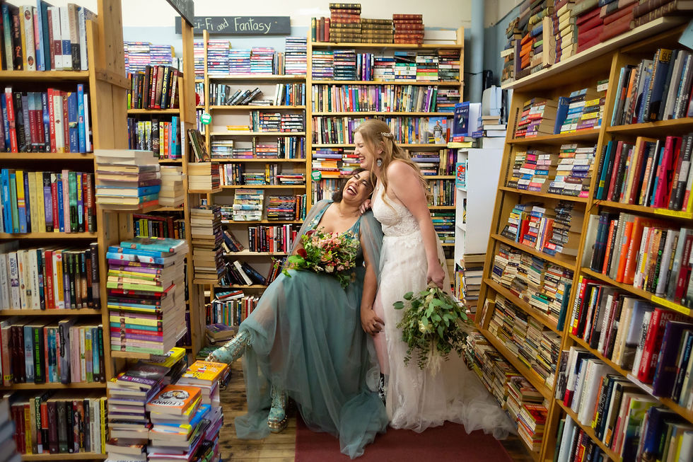 brides laughing in Turn the Page Book store Buffalo ny lgbtq same sex elopement