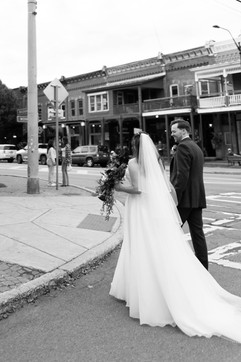 bride and groom walking down main street in the mountain town of ellicottville ny