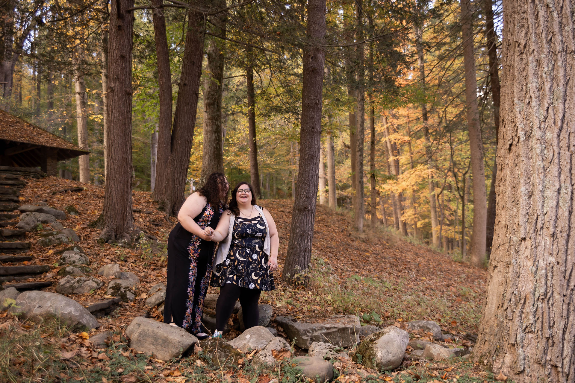 woman leads her fiancee down stone steps