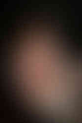 tattooed pin up boudoir model on her knees in vintage clawfoot tub