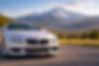 Silver sedan with clear headlights overlooking the Colorado foothills, representing professional mobile headlight restoration service in Lafayette, Colorado