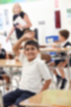 A link to the Elementary School Academics page. The image shows an elementary school student raises his hand during class at Saint Nicholas Catholic School in Los Altos California