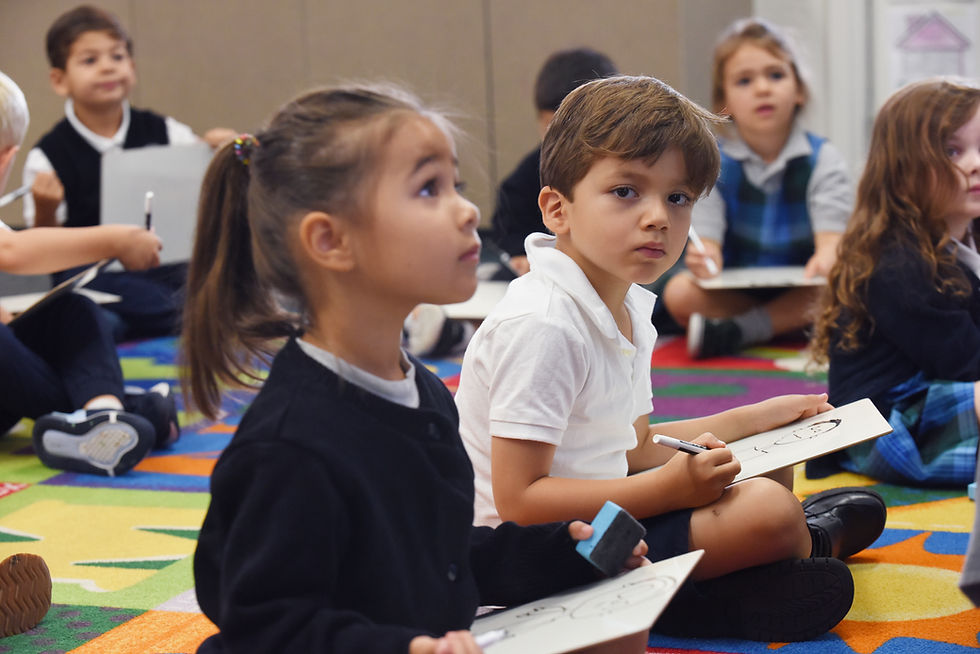 This image links to the main Support page. It depicts two kindergarten students at Saint Nicholas Catholic School learning how to write on white boards.