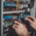 someone fixing some wiring but you cant see their body just their hands and the wires.jpg