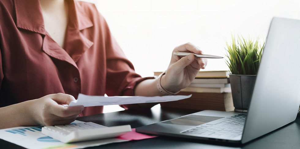 close-up-businessman-hand-holding-pen-pointing-financial-paperwork-financial-charts-analyz