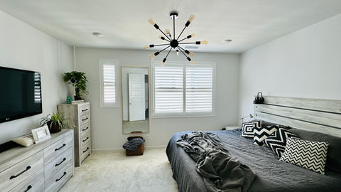white plantation shutters in the bedroom window