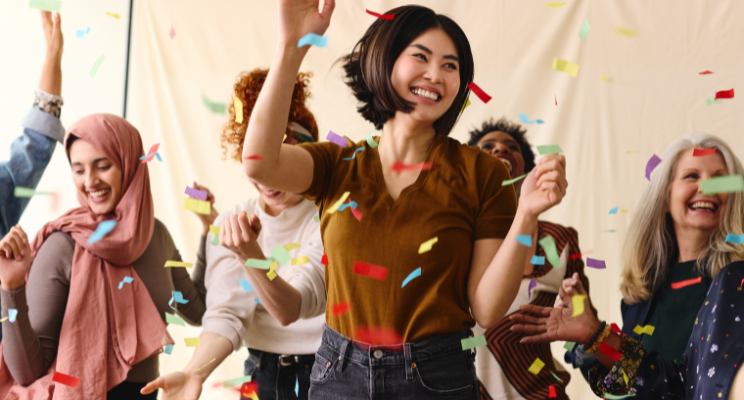 women celebrating under a shower of confetti