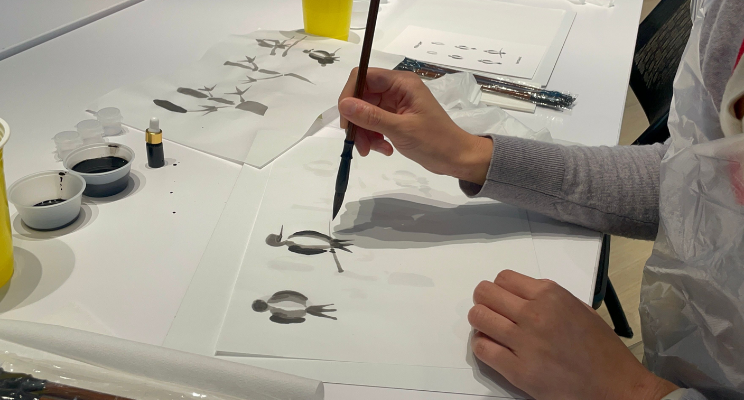 a person creating his sumi-e painting creation