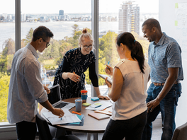 a group of colleagues working together in person