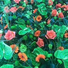 A table full of vibrant tropical flowers ready for a hands-on floristry class.