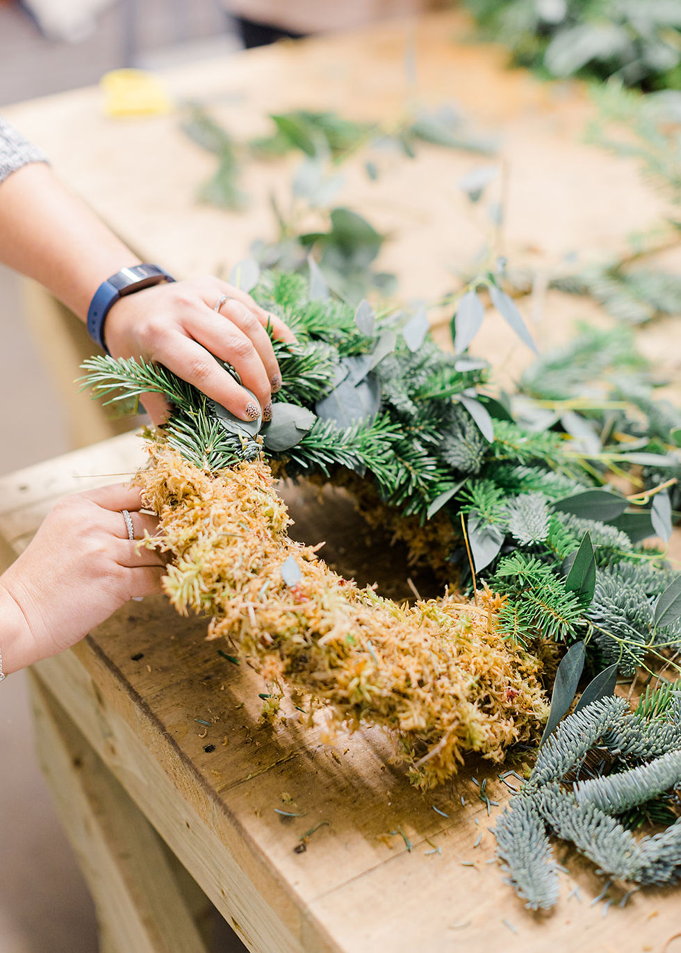 A standout Christmas wreath begins with the right foundation and follows with thoughtful layering. The key elements of a beautiful, long-lasting wreath include eco friendly moss, a wire ring and a mix of foliages