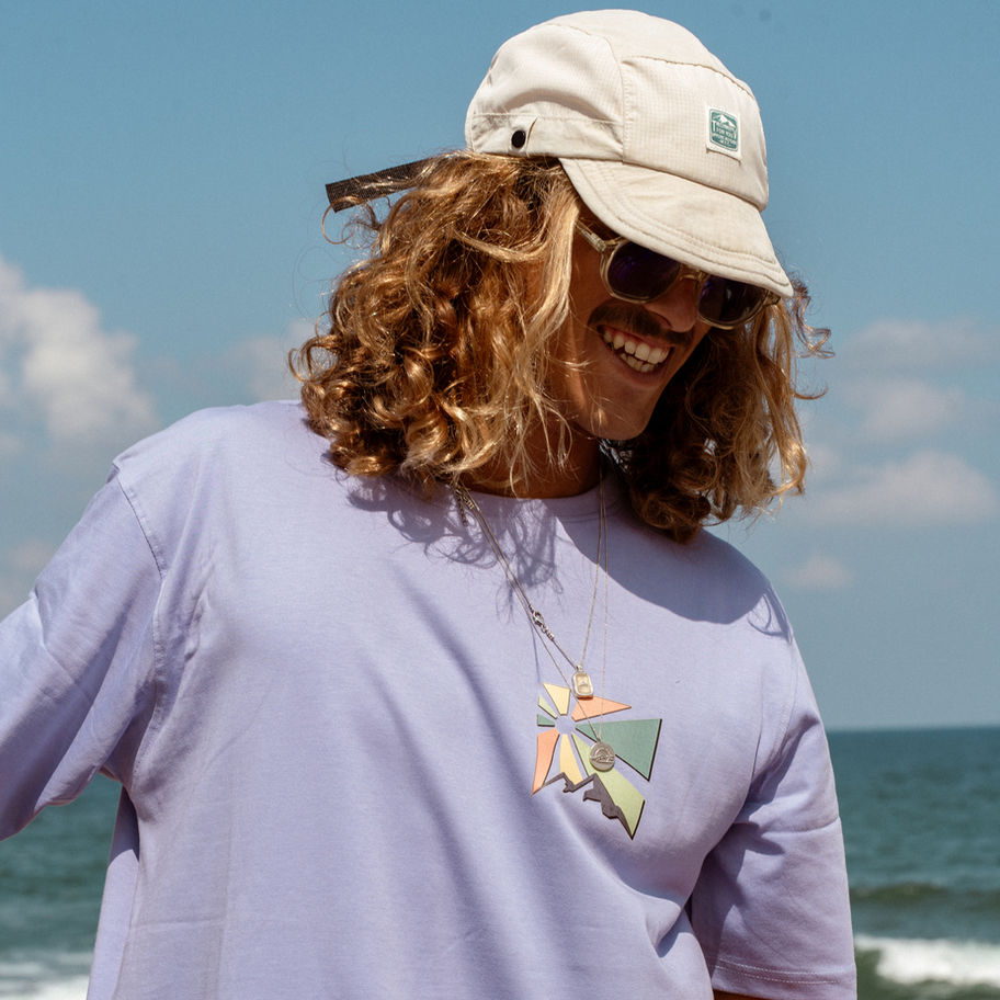 Model wearing Surf Wagon Tee, Grey, Unisex, at the beach