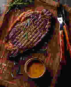 Grilled steak on a cutting board.