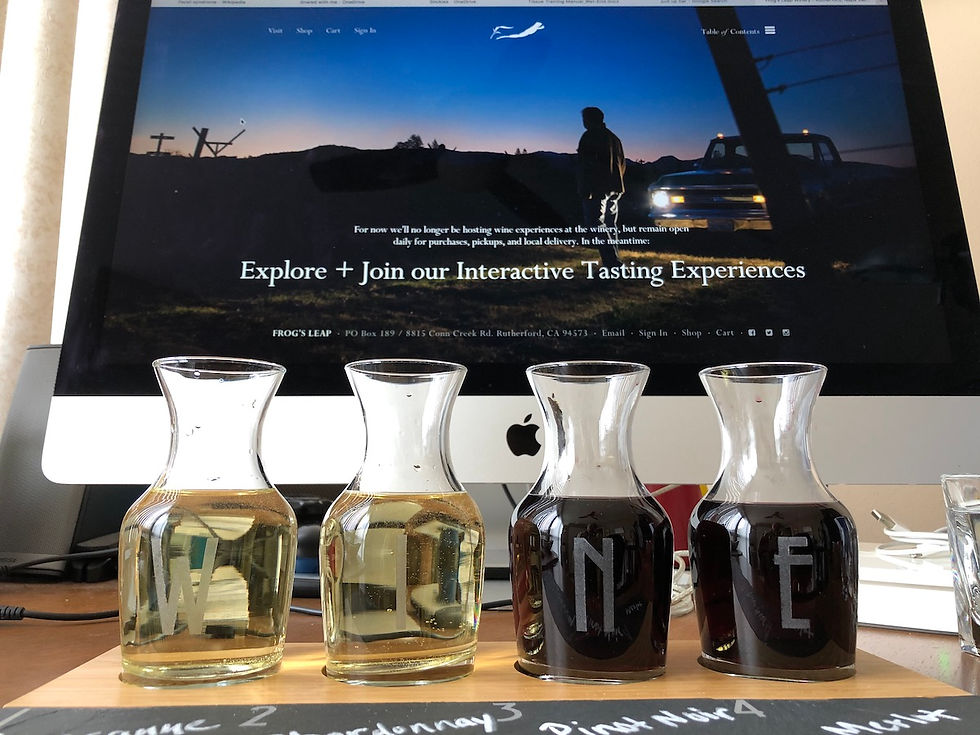 Wine tasting carafes in front of computer showing virtual tasting events.