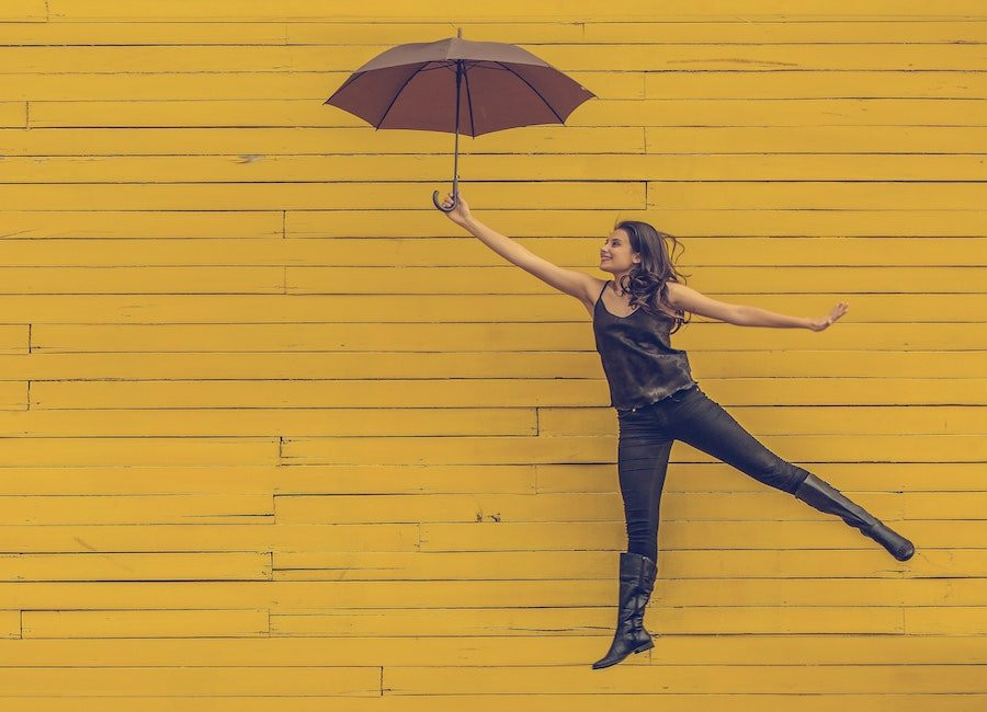 Woman flying away with umbrella.