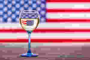 American flag and glass of white wine