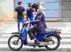 Man on a moving moped.