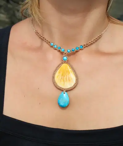 A one-of-a-kind seashell and gemstone macrame necklace worn on the neck, featuring delicate boho beading and handmade craftsmanship in Australia. An exclusive beach-inspired choker blending elegance and earthy design.