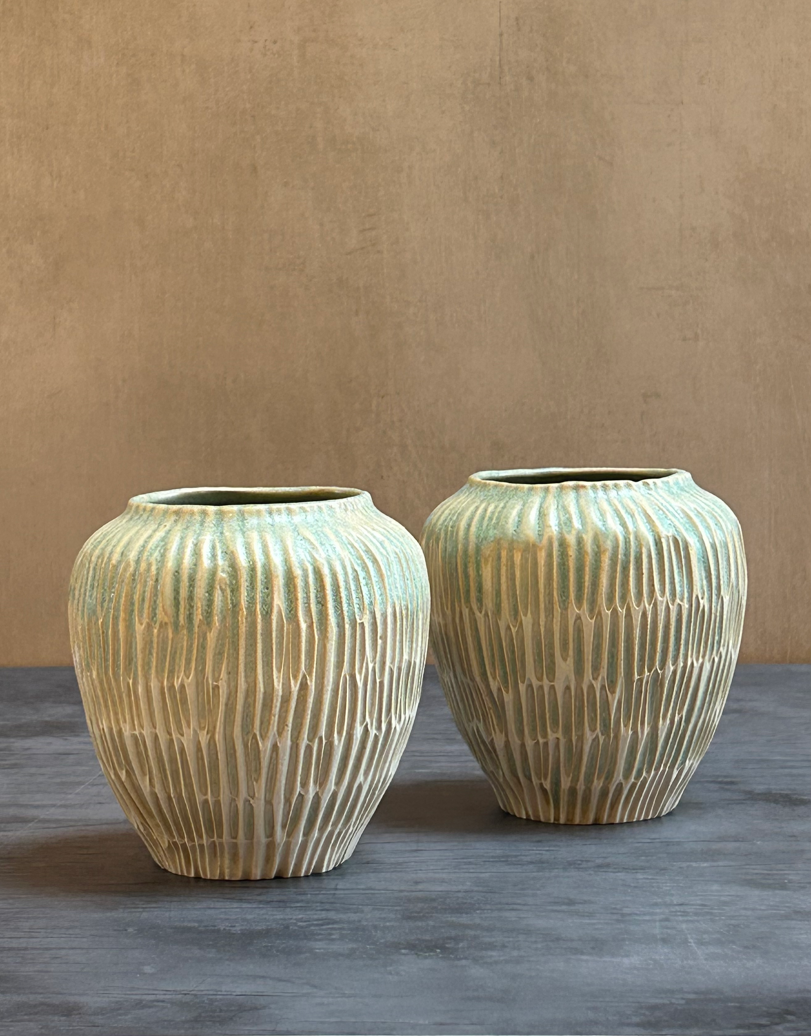 Light teal hand carved pair of vases