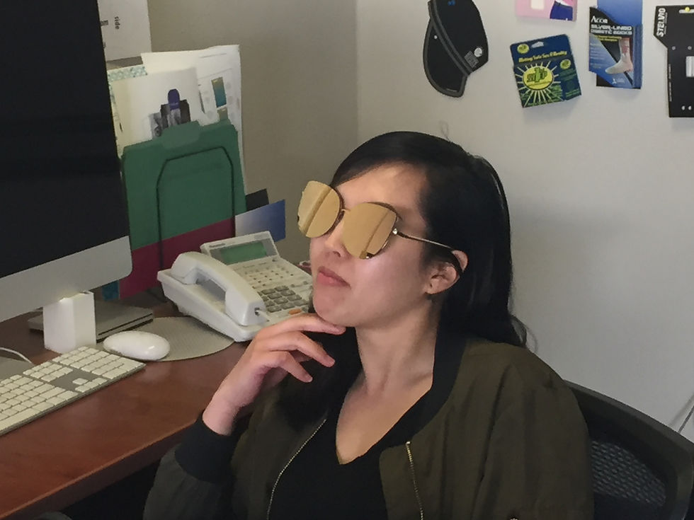 Box designer sitting at her desk pondering a box design