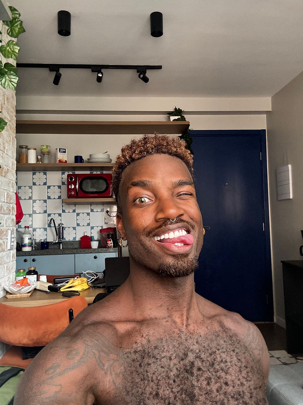 Amir Morris smiling with ombre ash brown curly fade