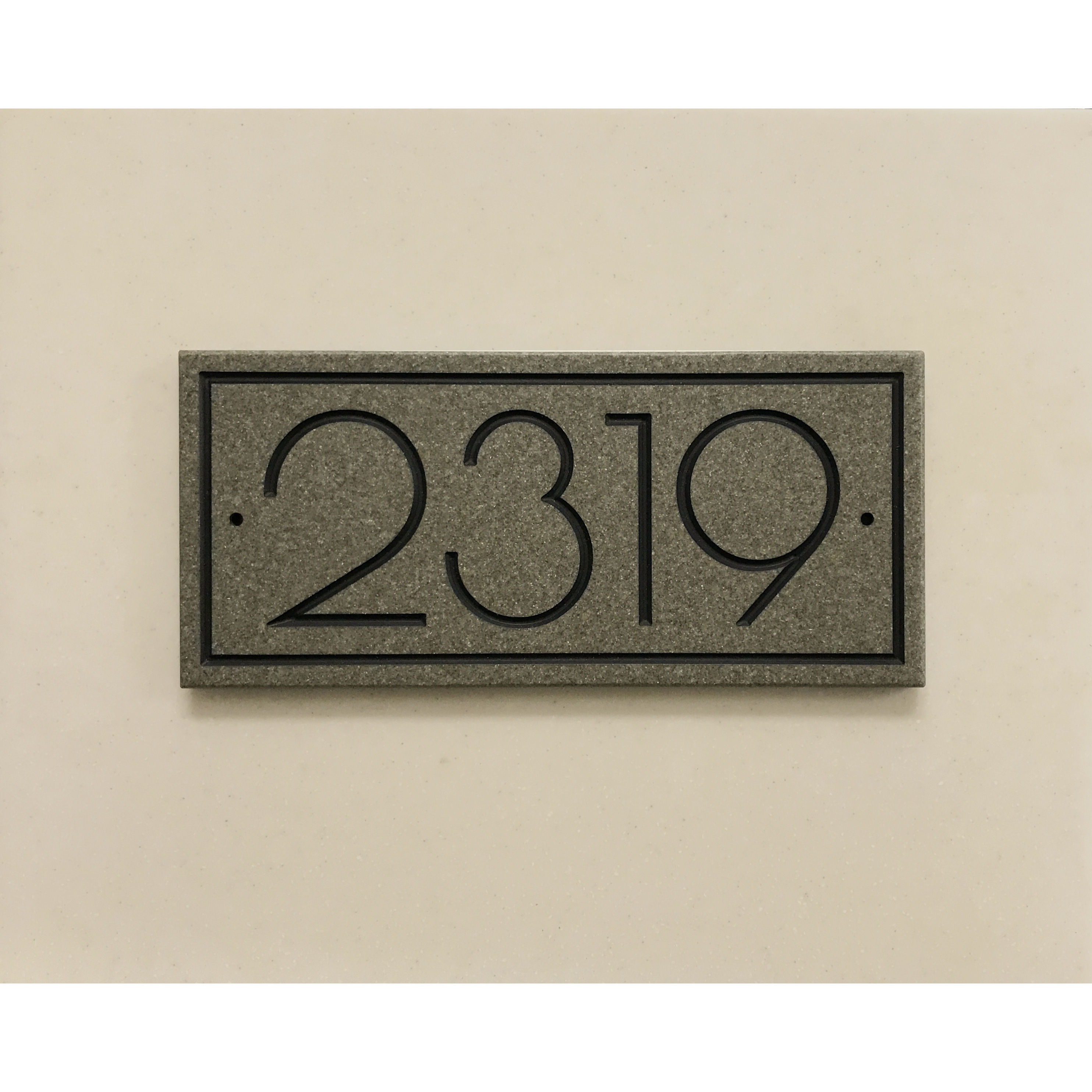 Modern address plaque featuring V-carved house numbers on a weatherproof, stone-look solid surface material.