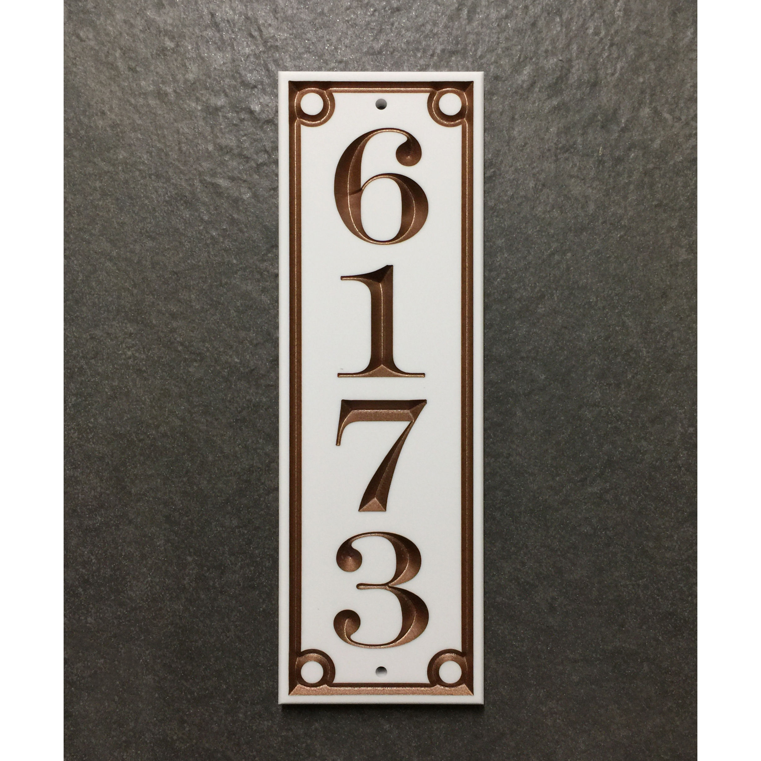 Eclectic address plaque featuring V-carved house numbers on a weatherproof, stone-look solid surface material.