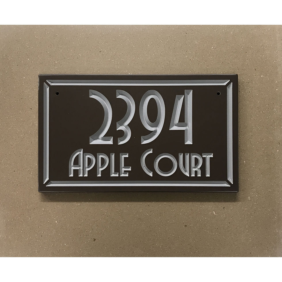 Mitred address plaque featuring V-carved house numbers on a weatherproof, stone-look solid surface material.