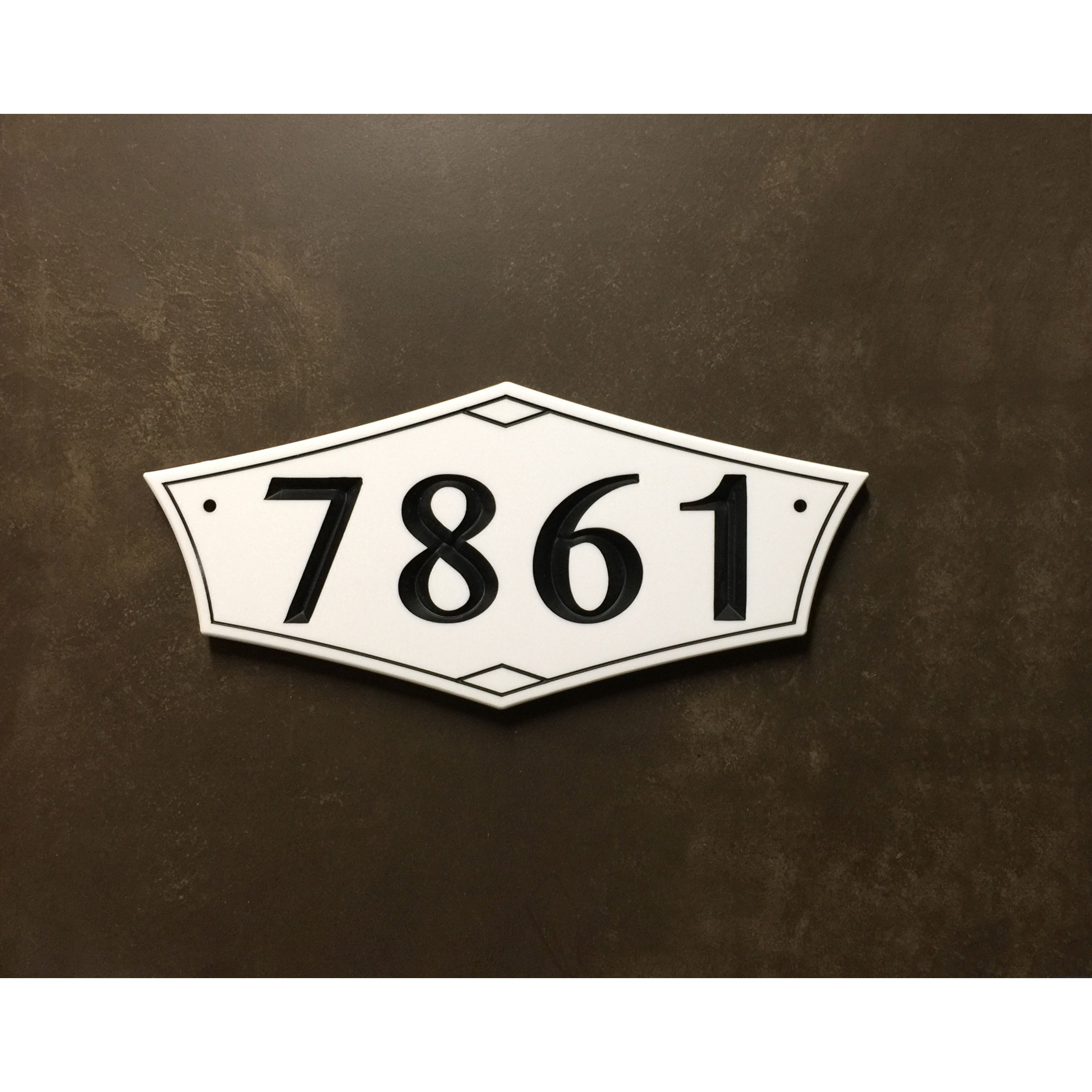 Mid century modern address plaque featuring V-carved house numbers on a weatherproof, stone-look solid surface material.