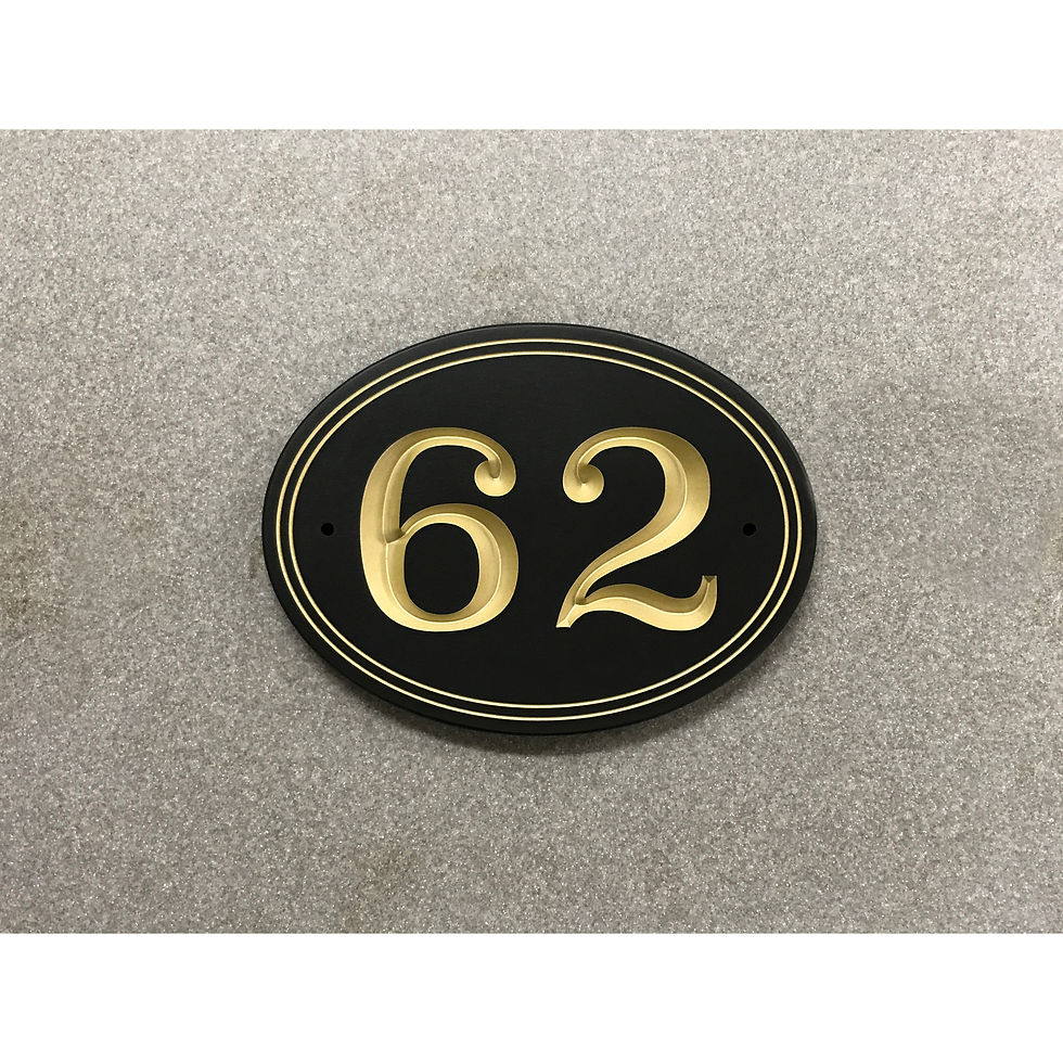 Short oval address plaque featuring V-carved house numbers on a weatherproof, stone-look solid surface material.