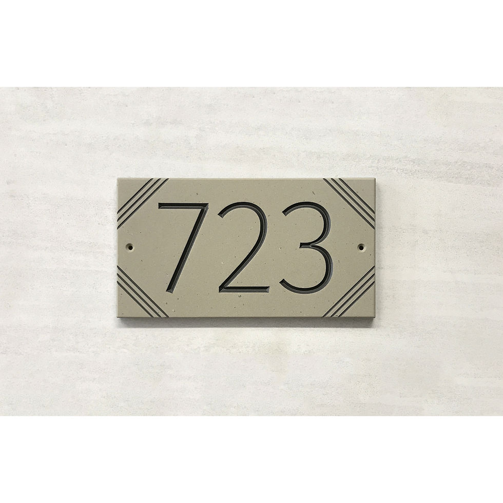Stylized octagon address plaque featuring V-carved house numbers on a weatherproof, stone-look solid surface material.