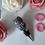 Thumbnail: handmade polymer clay bottle stopper of a gray cat on stainless steel laying on table