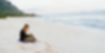 woman writing on a beach