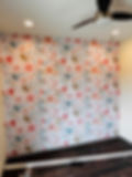 “Pink floral wallpaper accent wall in San Antonio bedroom with colorful pattern.