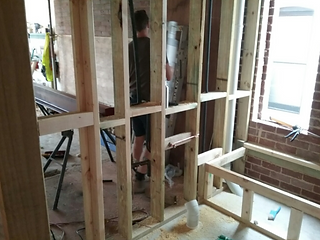 Wall frame dividing kitchen and bath