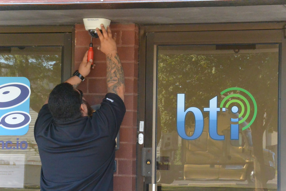 BTI Technician installing Axis Security camera