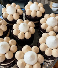 Individual devils food cakes layered with a hazelnut whipped ganache and topped with both house made whipped cream and a hazelnut praline.