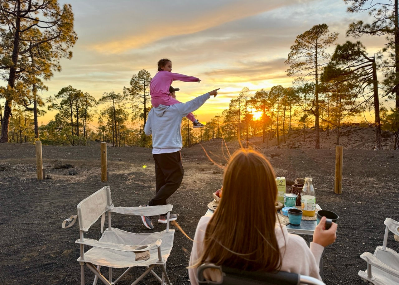 People relaxing at sunset near Volkswagen California 6.1 Ocean campervan in Tenerife.
