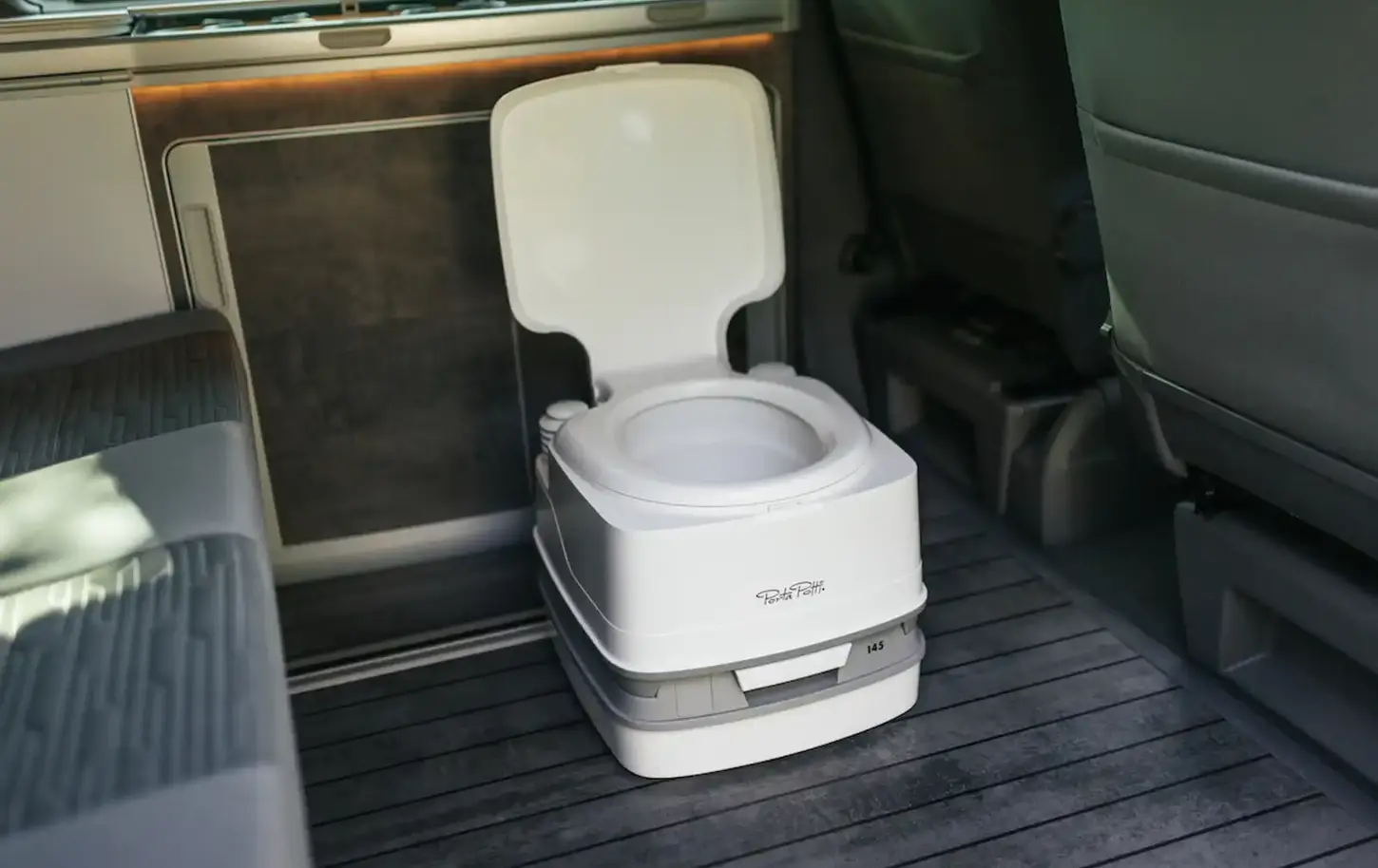 Portable camping toilet stored inside Volkswagen California 6.1 Ocean campervan.