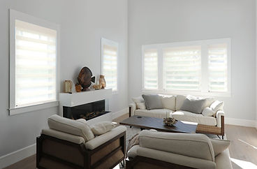 Living room with sheer fabric shades softly filtering sunlight.