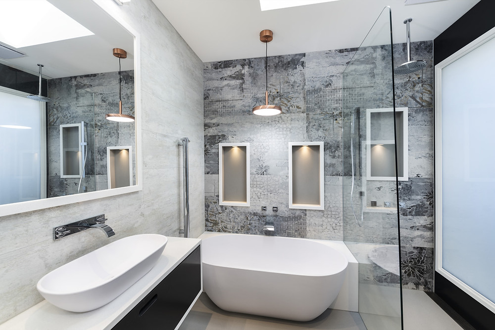Compact luxury Ensuite bathroom, complete with a semi freestanding bath and a switch glass window. Perfect example of how to make small bathrooms feel large