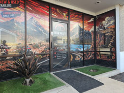 Deer Valley Trailer dealership entrance in North Phoenix, Arizona, specializing in utility, dump, enclosed, equipment, and custom trailers.