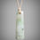 Miniature : White jade adze pendant (Happy Camp grossular) on tan cord, front view