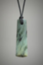 Blue nephrite adze pendant on black cord, front view