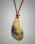 Golden grossular garnet drop pendant on brown cord, front view”
