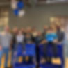 Synagex team photo with two children sitting on blue tool chests